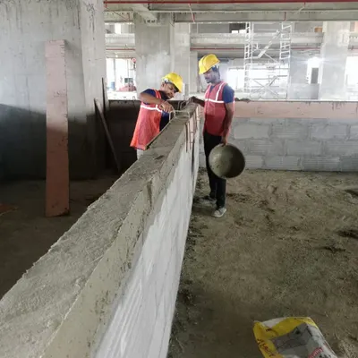 Here, my team is engaged in blockwork construction at the Mediatek site in Noida. This is a crucial phase where the interior layout begins to take shape, requiring precision and adherence to the architectural plans.