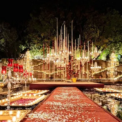 The raw beauty of Alila Fort Bishangarh in Rajasthan provided a dramatic canvas for this floating mandap. We redesigned the decor multiple times to work with the rain, ultimately creating a charming, dreamlike setting that embraced the elements.
