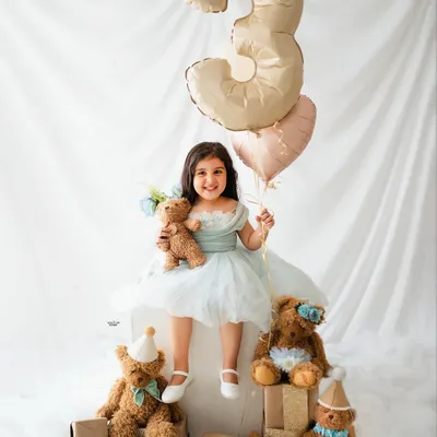 Celebrating a third birthday with a sky full of balloons and a party of teddy bears! This little princess is all smiles for her special milestone photoshoot.