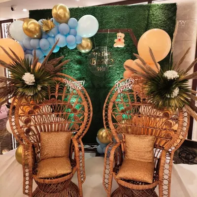 We offer special seating to make the parents-to-be the center of attention. These stylish peacock chairs, set against a greenery wall, provide a perfect and comfortable spot for the guests of honor.