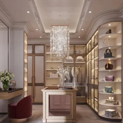 This luxurious walk-in closet features a stunning rectangular crystal chandelier as its centerpiece. The design includes a mix of open shelving for display, glass-door cabinets for protection, and a vanity area with a bold red stool.