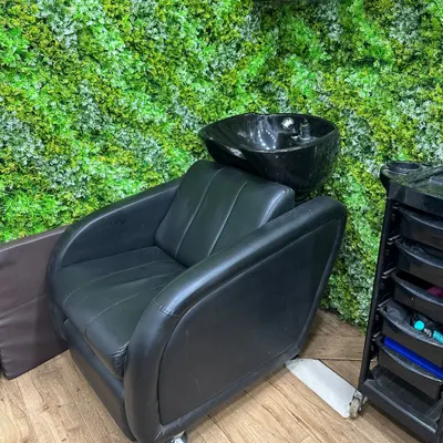This is my dedicated hair wash and treatment station. It's set against a calming green wall, creating a relaxing environment for services like a pre-treatment wash or a deep conditioning hair spa.