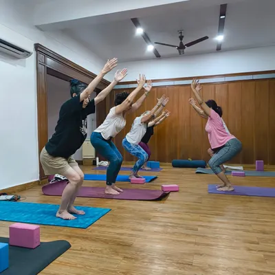 The powerful energy of a group practicing Utkatasana, or chair pose. In my classes, we build strength and stamina together, motivating each other every step of the way.