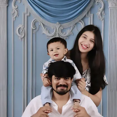 A classic family portrait with the little one taking center stage on dad's shoulders. My studio sets provide a beautiful backdrop for these timeless memories.