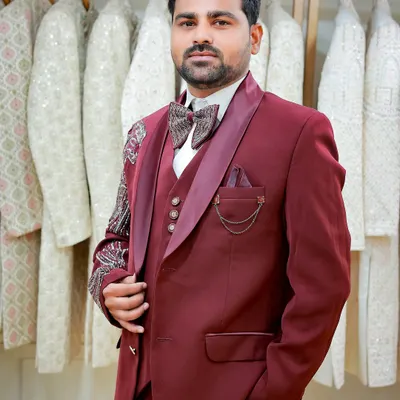 A sharp portrait of the groom in a stylish maroon three-piece suit. This was taken during his outfit selection, a part of the wedding journey I can also cover.