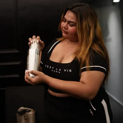 Every participant gets to try their hand at being a mixologist. Here, a guest is learning how to use a cocktail shaker, one of the fundamental skills we teach in our beginner-friendly sessions. It's all about getting involved and having a great time.