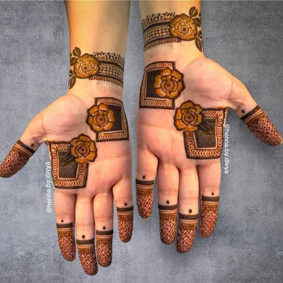 A modern and chic design featuring bold, framed roses. The use of negative space and clean lines gives this mehendi a very contemporary feel.