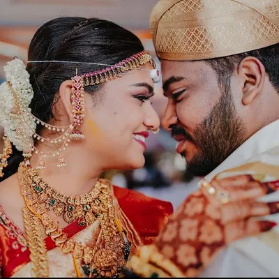 An intimate close-up of a newly married couple. This photo focuses on their emotional connection, capturing the quiet moment of love and respect between them.