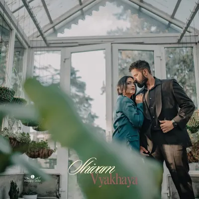 A romantic embrace inside a beautiful glasshouse in Mussoorie. The soft light and lush greenery create a dreamy, intimate setting for a destination pre-wedding photoshoot.
