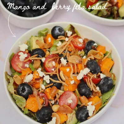 A fresh and vibrant Mango and Berry Feta Salad, part of our seasonal mango menu. It's a perfect light meal or a refreshing side dish, bursting with summer flavors.