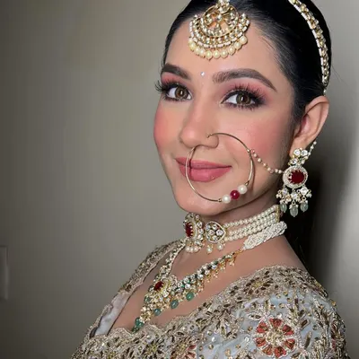 A close-up of this stunning bridal look. Notice the soft, blended eyeshadow, the perfectly defined brows, and the radiant skin. Her smile says it all.