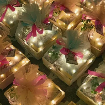 Light up your Diwali with our magical gift hampers. These pinewood trays are filled with goodies and wrapped in tulle with fairy lights, creating a truly dazzling effect when illuminated.