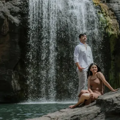 A beautiful couple portrait set against a cascading waterfall. The natural setting provides a powerful and serene backdrop for this pre-wedding shoot.