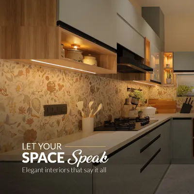 Let your space speak with elegant interiors. This kitchen features a beautiful floral backsplash, sleek grey cabinets, and warm wood accents, creating a perfect blend of modern design and classic charm.