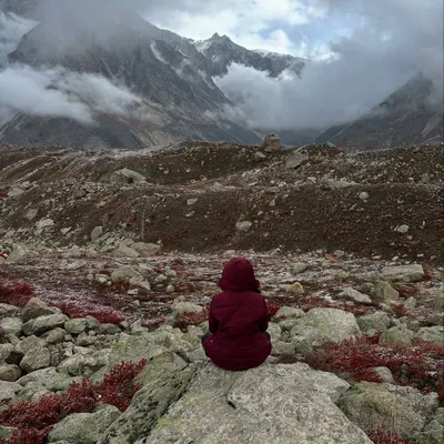 Sitting in stillness amidst the raw, majestic landscape of the Himalayas during our Tapovan trek. In moments like these, you realize the mountains, the sky, and the silence are all reflections of what is already within you.