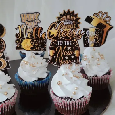 A closer look at my New Year celebration cupcakes. These feature a festive black and gold theme with fluffy white frosting, gold sprinkles, and custom printed toppers to ring in the new year with style.