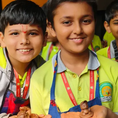 Two young students from Gopal's Garden School proudly show off the miniature clay articles they made. Their smiles say it all; our workshops are a joyful and creative experience for kids.