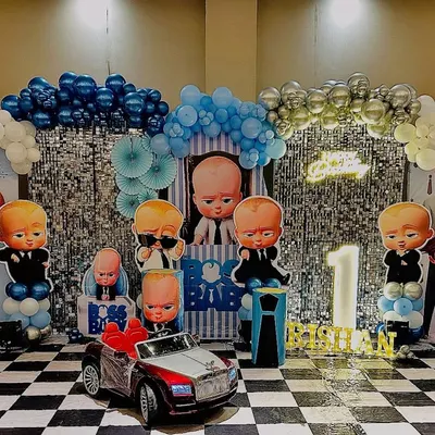 Here is a full view of one of my popular Boss Baby themed decorations. The setup includes a wide shimmer backdrop, a complete set of character cutouts, themed balloon columns, and a checkered floor to match the theme's style.