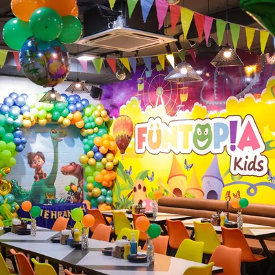 Our cafe area fully transformed for a dinosaur-themed party. The colorful chairs, themed decorations, and spacious seating create a vibrant and comfortable atmosphere for guests.