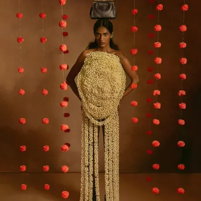 An avant-garde fashion statement where the model becomes a living sculpture of flowers. This is a testament to collaborative creation, blending styling, concept, and photography into a single piece of art.