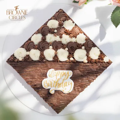 Another look at my signature fudgy brownie cake, ready for a birthday celebration. This one features a textured chocolate finish and a border of delicate buttercream swirls.