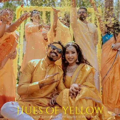 A joyful couple, surrounded by friends and family under a shower of yellow petals during their Haldi ceremony. This image, titled "Hues of Yellow," perfectly captures the vibrant energy of the day.