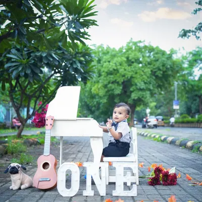 Celebrating the big ONE! This little boy looks so dapper with his miniature piano and guitar. An outdoor milestone shoot is a wonderful way to mark a first birthday.