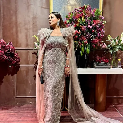 Dressed for a glamorous evening of hosting. This sparkling gown with a dramatic cape is perfect for making a statement at a cocktail or reception night.