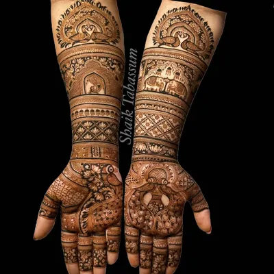 A masterpiece of traditional motifs, this design is filled with graceful peacocks and royal elephants. The intricate patterns and shading showcase the depth and beauty of classic henna art.