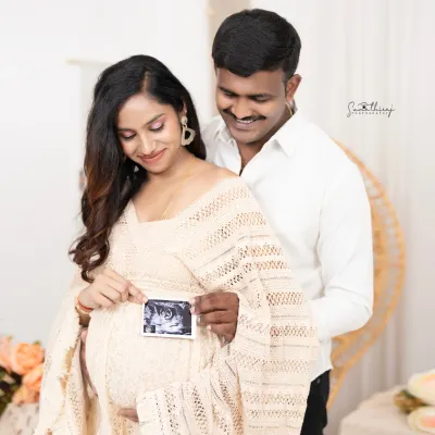 A beautiful boho-chic portrait of a couple holding their baby's first ultrasound picture. The natural textures and soft lighting create a warm and intimate atmosphere.