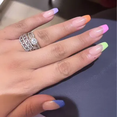 A playful and colorful take on the French manicure with a different pastel shade on each nail tip, perfect for a fun, summery look.