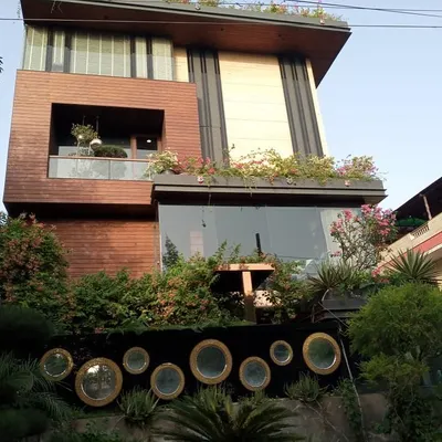 A full view of a modern villa in Noida where I designed and installed integrated greenery on the ground floor, balconies, and a full rooftop garden.
