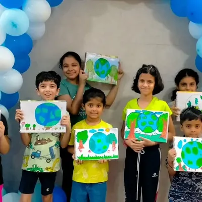 A group of proud young artists showing off the Earth paintings they created during a workshop. Our art activities are a great way to add a creative touch to any party.