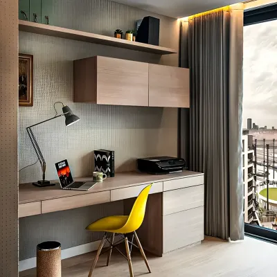 A compact and efficient home office nook with a view. The floating desk and wall-mounted cabinets in a light wood finish maximize floor space, while the bright yellow chair adds a pop of color and energy.