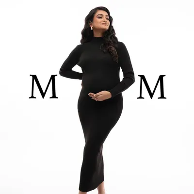 A powerful and stylish full-length portrait in a classic black turtleneck dress. The simple white background and bold "MOM" text make a modern statement.