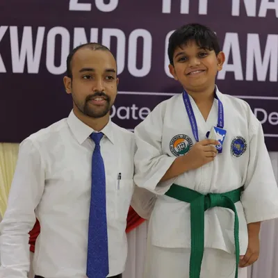 Posing with a young student and his new medal at the ITF National Taekwon-Do Championship. Seeing my students succeed is the greatest reward.