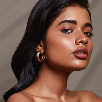 A soft, luminous beauty portrait with a focus on glowing skin and natural makeup. This shot highlights my ability to use subtle lighting to sculpt features and create a flawless, dewy look.