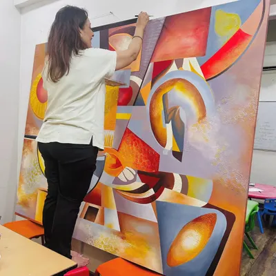 Creating a large commissioned piece is a labor of love and intense focus. Here I am, standing on a stool to reach the top of the 5.5 by 7 feet "The Sounds of Music" canvas, ensuring every part of the composition is perfect.
