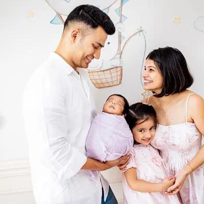 A beautiful family of four celebrating their newest member. I love capturing these moments against the backdrop of your baby's own nursery.