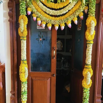 A traditional door decoration for a housewarming ceremony. I used garlands of yellow chrysanthemums and jasmine, with hanging lotus buds for an elegant and auspicious touch.