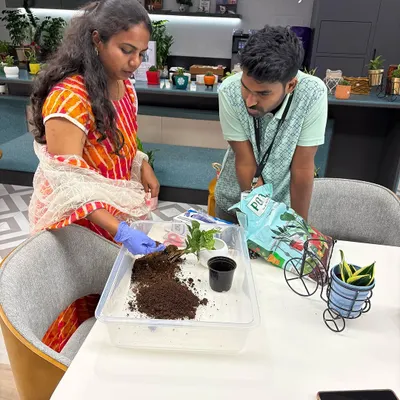 This is where it all begins. I'm showing a client how to pot her new plant, explaining the importance of the right soil mix. I love empowering my clients to become confident plant parents.