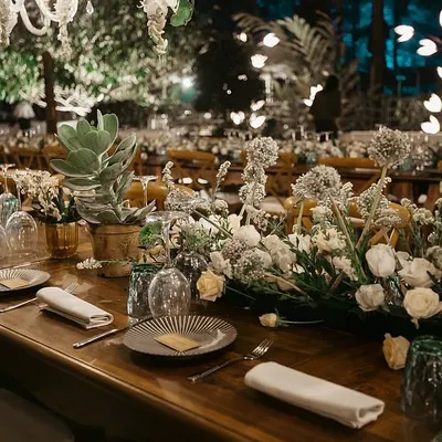 For this wedding dinner in a Coorg forest, we created an enchanting tablescape with long wooden tables, lush white and green floral runners, and elegant glassware. The entire setup, including a 7-course meal, was managed in a location with zero connectivity.