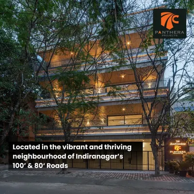 The Panthera RoofGardens project in Indiranagar, viewed from the street, shows our use of natural wood tones and vertical lines to create a warm, modern apartment building.