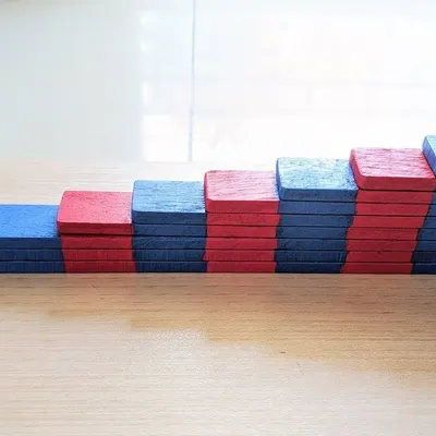 These are my handmade Number Rods, a foundational Montessori tool for understanding quantity. As a child arranges these red and blue blocks, they are not just counting; they are physically experiencing the progression of numbers and the relationship between them, which is the first step towards understanding arithmetic.