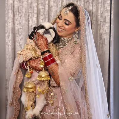 A bride and her best friend. It was so special to see her enjoying her wedding day with her furry companion, her beautiful henna stain adding to her bridal glow.