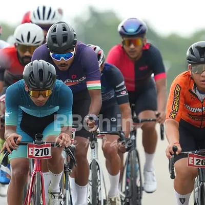 The elite peloton is a blur of color and speed. Here, riders are tightly packed, drafting off one another in a display of high-stakes road racing strategy.