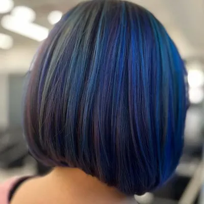 A mesmerizing fusion of teal and purple on a sharp bob. This shows how vivid colors can be used to create a sophisticated, high-fashion look.