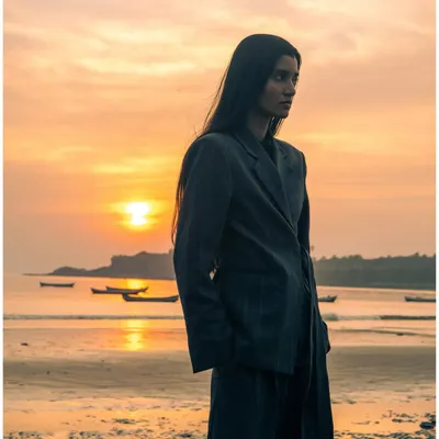 A different angle from the sunset beach shoot. This profile shot captures a more contemplative mood, with the warm light of the setting sun creating a beautiful rim light.