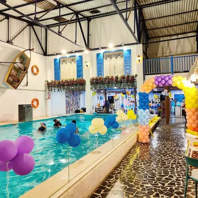 Our space transforms beautifully for any celebration. This shot shows a birthday party setup with colorful balloons and a festive atmosphere by the pool.