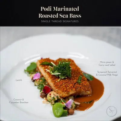 This is my Podi Marinated Roasted Sea Bass. The fish is crusted with a flavorful podi spice mix and served on a bed of coconut and cucumber banchan with a tempered tamarind and coconut milk nage.
